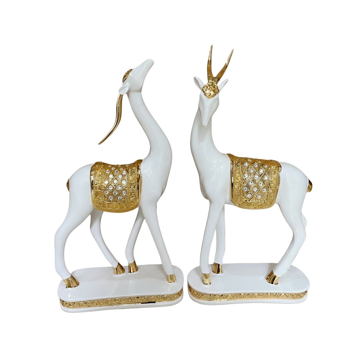 Decorative statues of white deer with gold accents on a white background